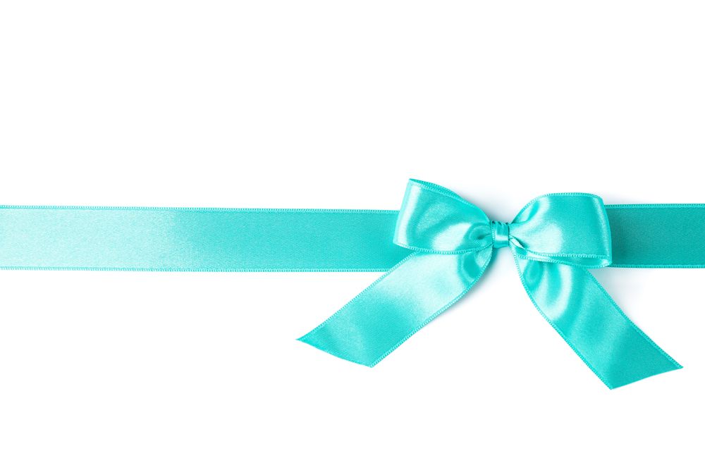 Turquoise ribbon with bow isolated on plain background. Gift concept