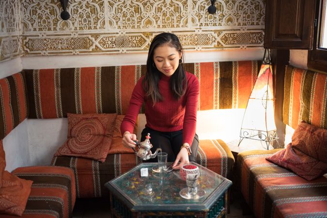 Asian woman enjoying Arabic tea