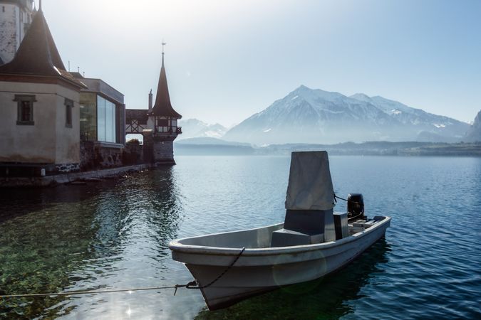 Boat at pier on lake in mountain landscape