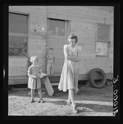 Young mother, twenty five, says "Next year we'll be painted and have a lawn and flowers."
