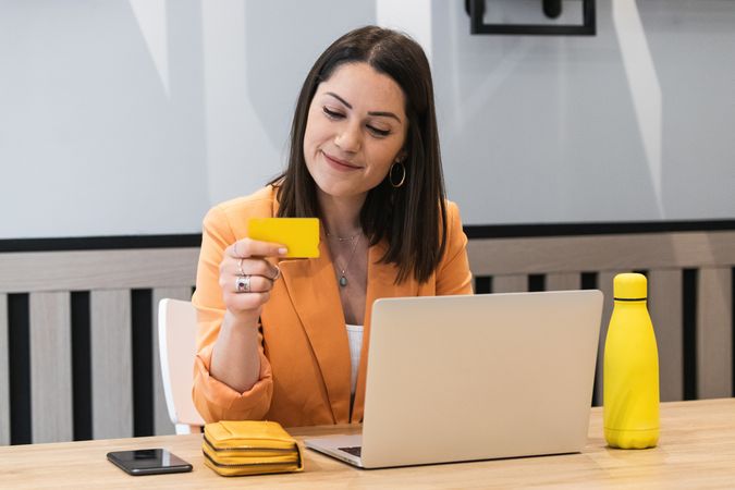 Happy woman making payment during online shopping