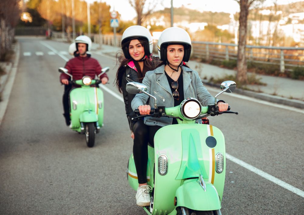 Young people riding motorcycles on city road