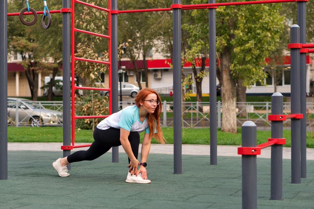 Woman stretching legs during outdoor workout