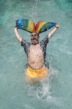Excited gay man in swimming pool