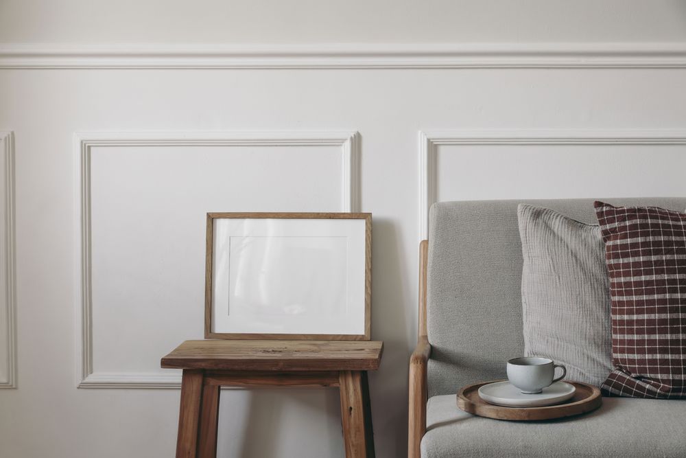 Blank horizontal wooden picture frame mockup on coffee table