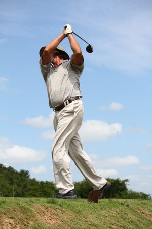Older man playing golf during daytime
