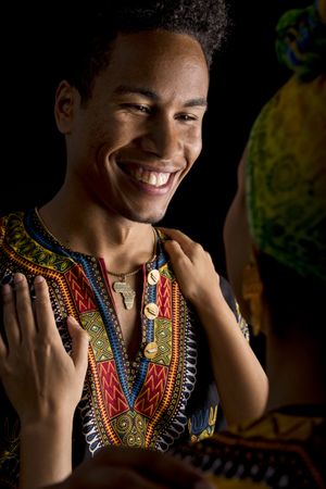 Black man smiling looking to hugging woman