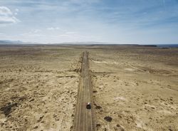 Car driving on road in picturesque desert