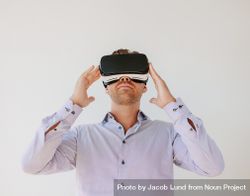 Shot of young businessman watching content on a virtual reality headset 42oe3b