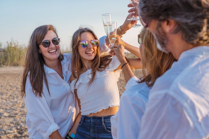Happy family drinking wine on beach