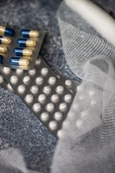 Top view of different pills and medical mesh