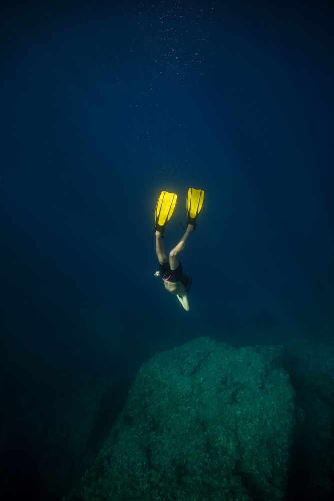 Diver in flippers swimming underwater
