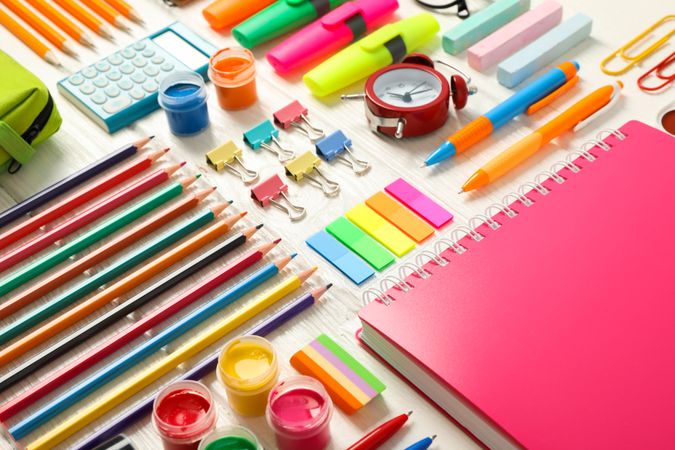 Flat lay composition with school supplies on wooden background