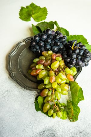 Fresh red & green grapes on grey plate
