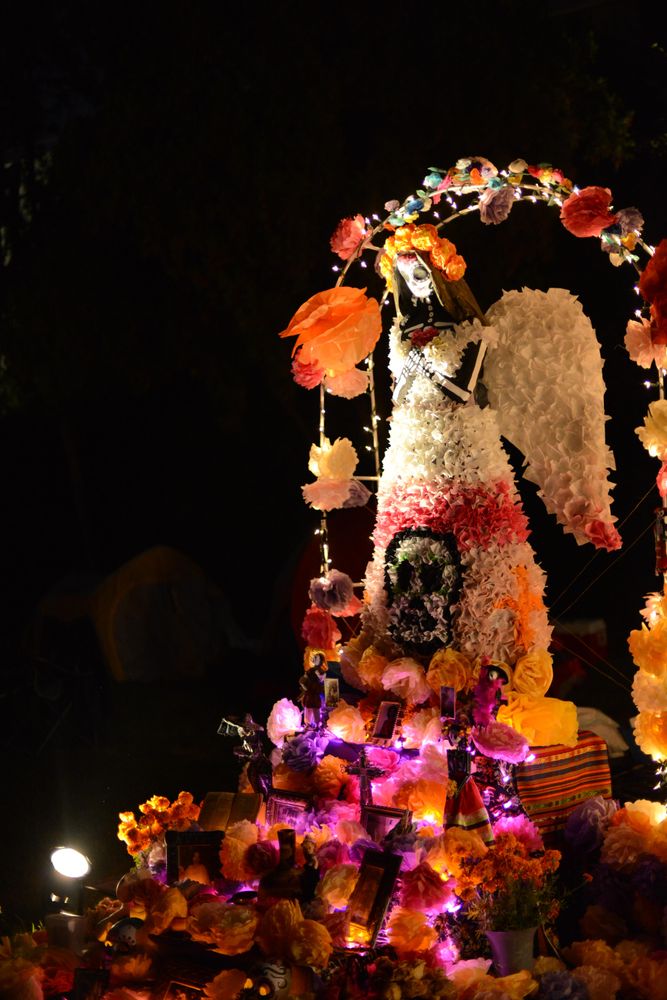 Paper Mache angel sculpture at atlar at Day of the Dead celebration at night
