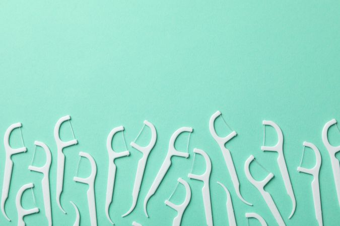 Toothpicks on mint background, space for text