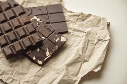Top view of stack of three chocolate bars on paper