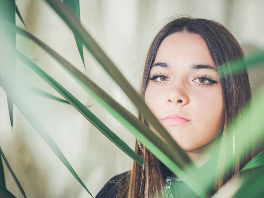 Woman between green leaves