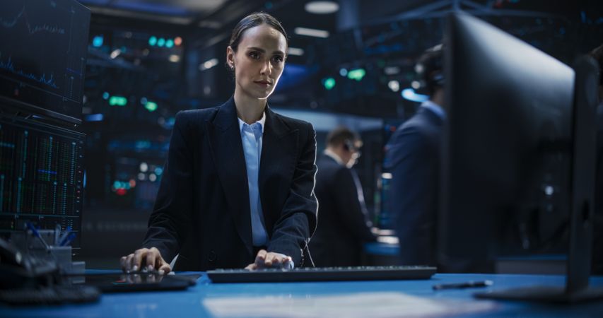 Portrait of a Female Stockbroker Working in an International Stock Exchange Office.