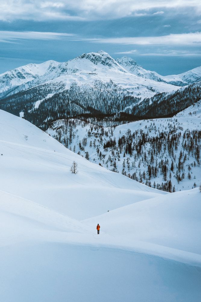 Person walking on snow covered mountain