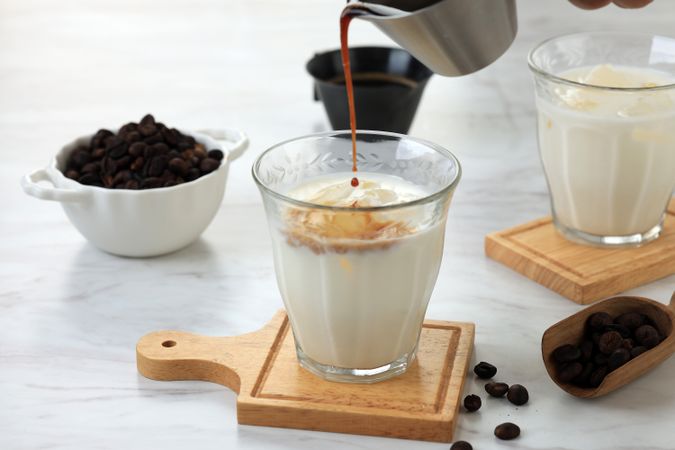 Pouring Espresso Shot to the Glass with Cold Fresh Milk