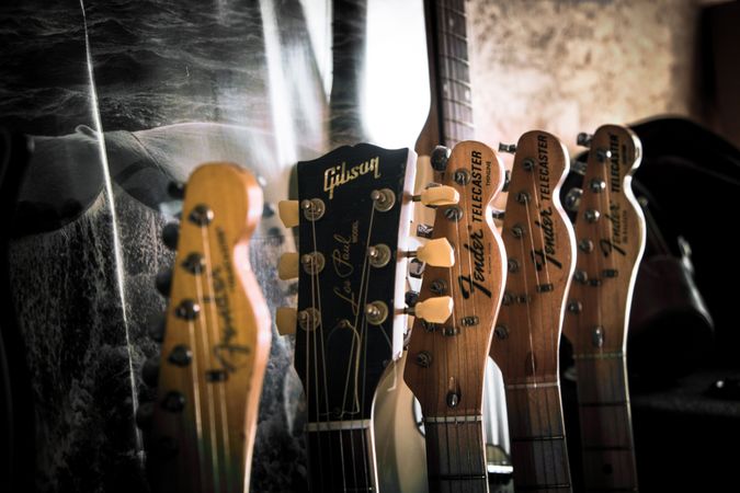 Tops of guitars lined up in a row