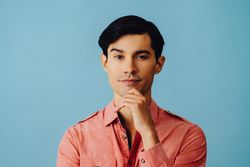 Portrait of curious Hispanic male looking at camera