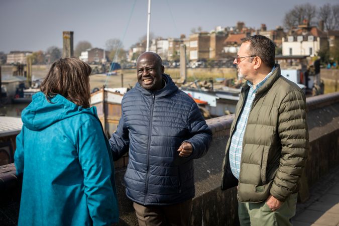 Multi-ethnic group of older adults chatting outside