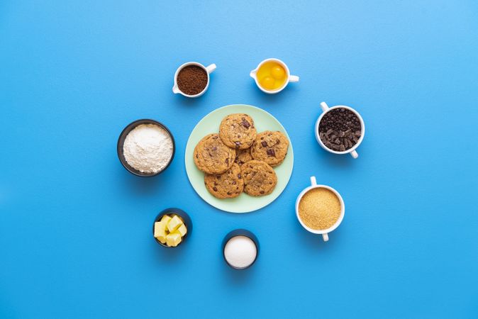 Chocolate chip cookies on a plate and the recipe ingredients