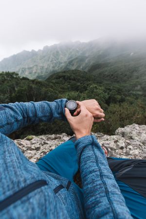 Man's hand with watch in the mountains