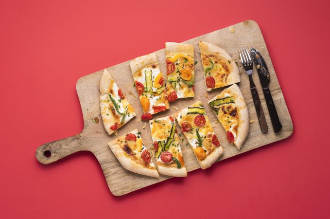 Sliced pizza primavera on wooden board
