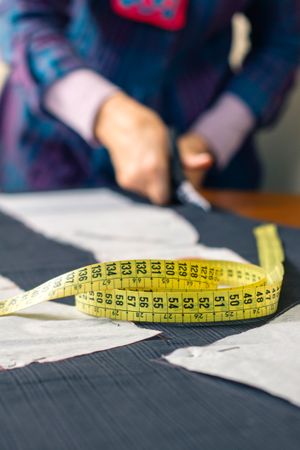 Measuring tape with dressmaker cutting in background