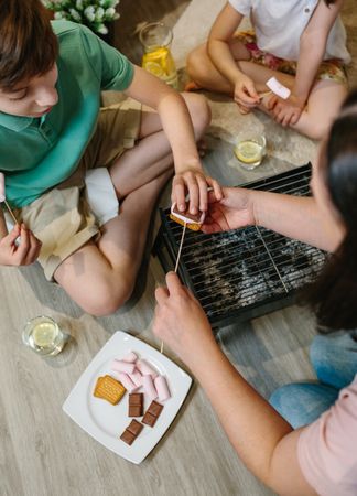 Top view of family preparing s'mores at home