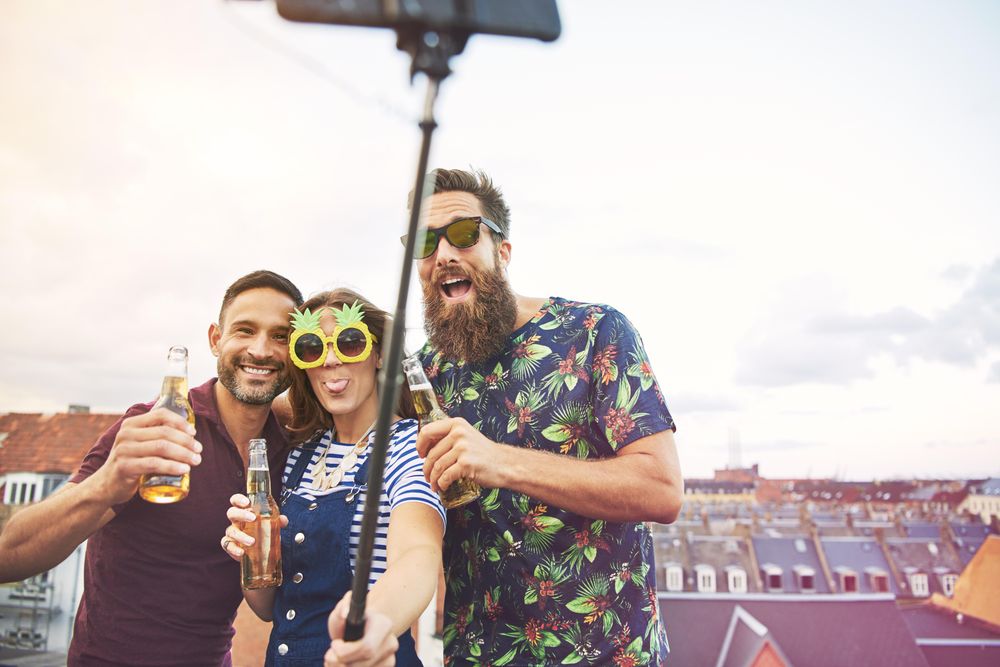 Group of three friends taking a picture of themselves having fun