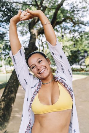 Happy woman stretching arms and smiling