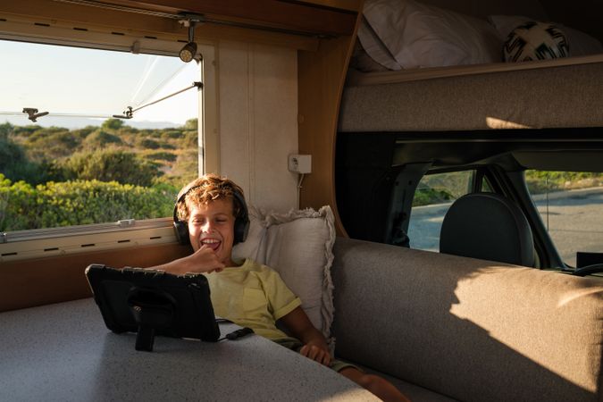 Happy boy watching film in RV