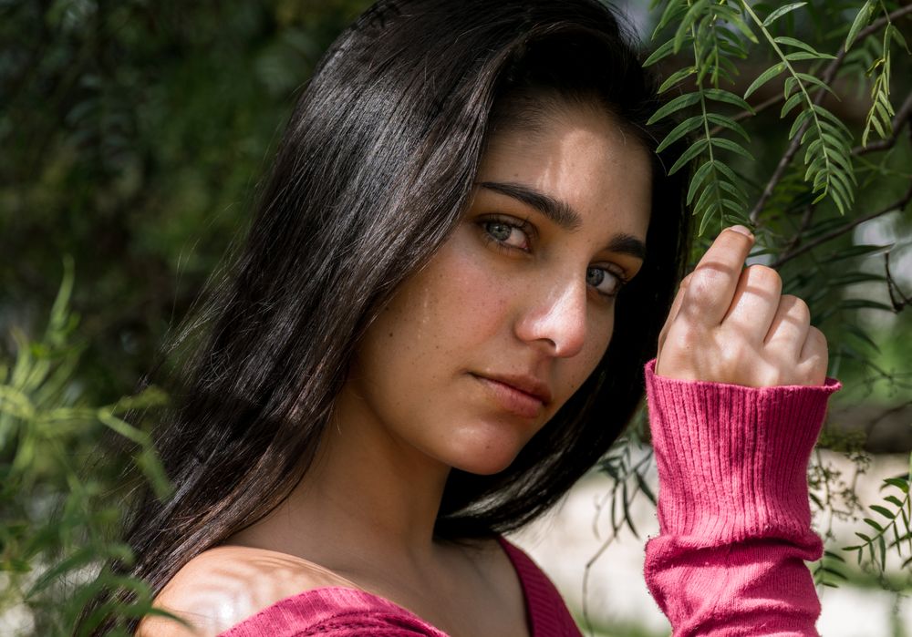 Young charming woman between flowers