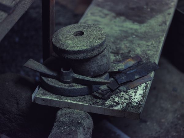 Metal parts on anvil in blacksmith workshop