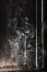 Smoke rising near a window
