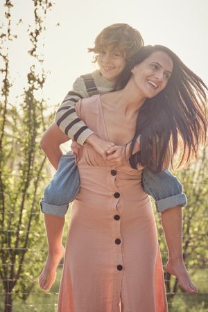 Happy woman with son in park