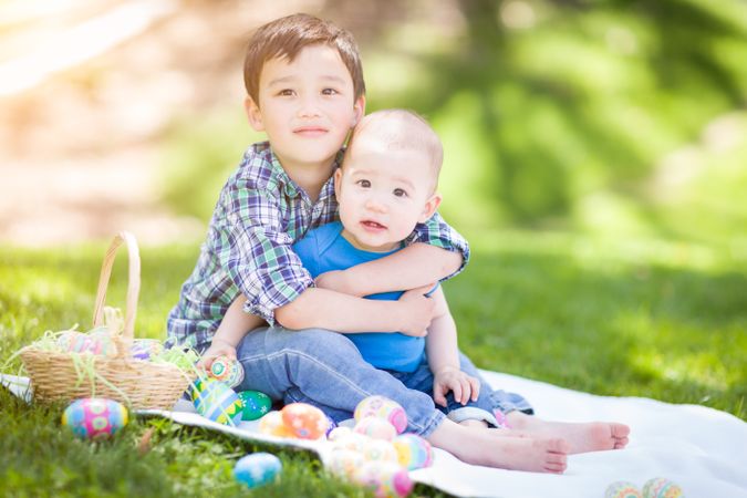 Boys Outside in Park Playing with Easter Eggs