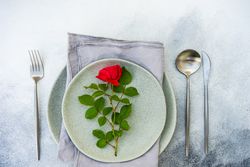 Top view of table setting with red rose