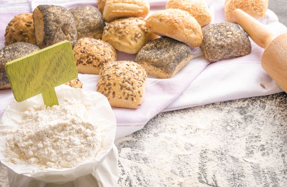 Wheat flour with banner and bread and rolls in the background
