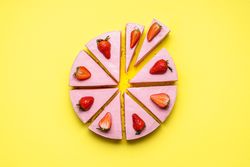 Strawberry cheesecake sliced in unequal pieces