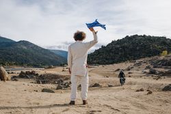 Man in jumpsuit waving blue flag at motorcyclist