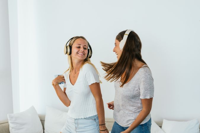 Cheerful women dancing while listening to music