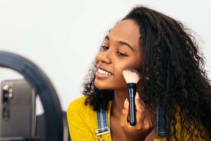 Beauty blogger promoting makeup on social media
