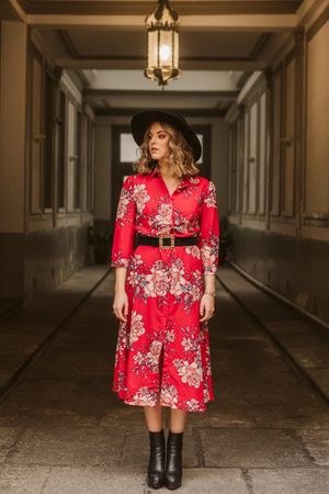 Elegant woman standing in old passage