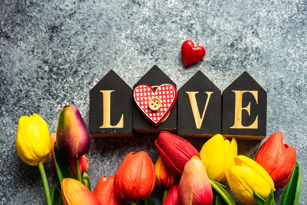 Valentine's day card concept with the word "love" and tulips