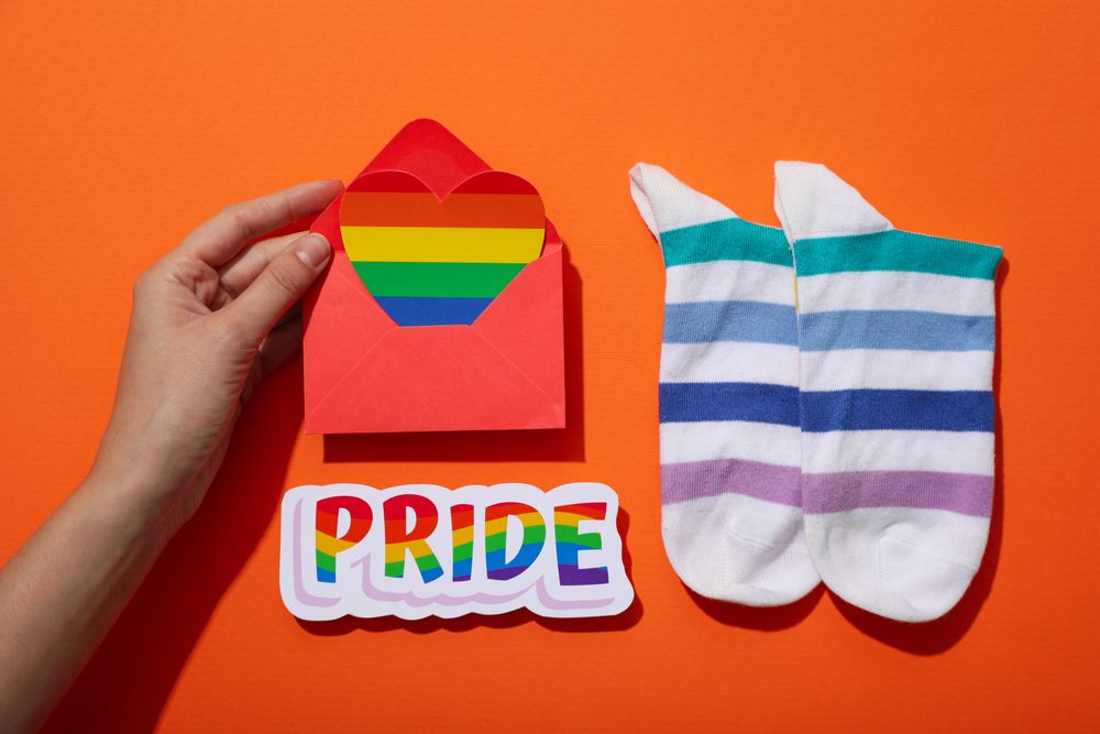 Pride parade concept, symbols on orange background.